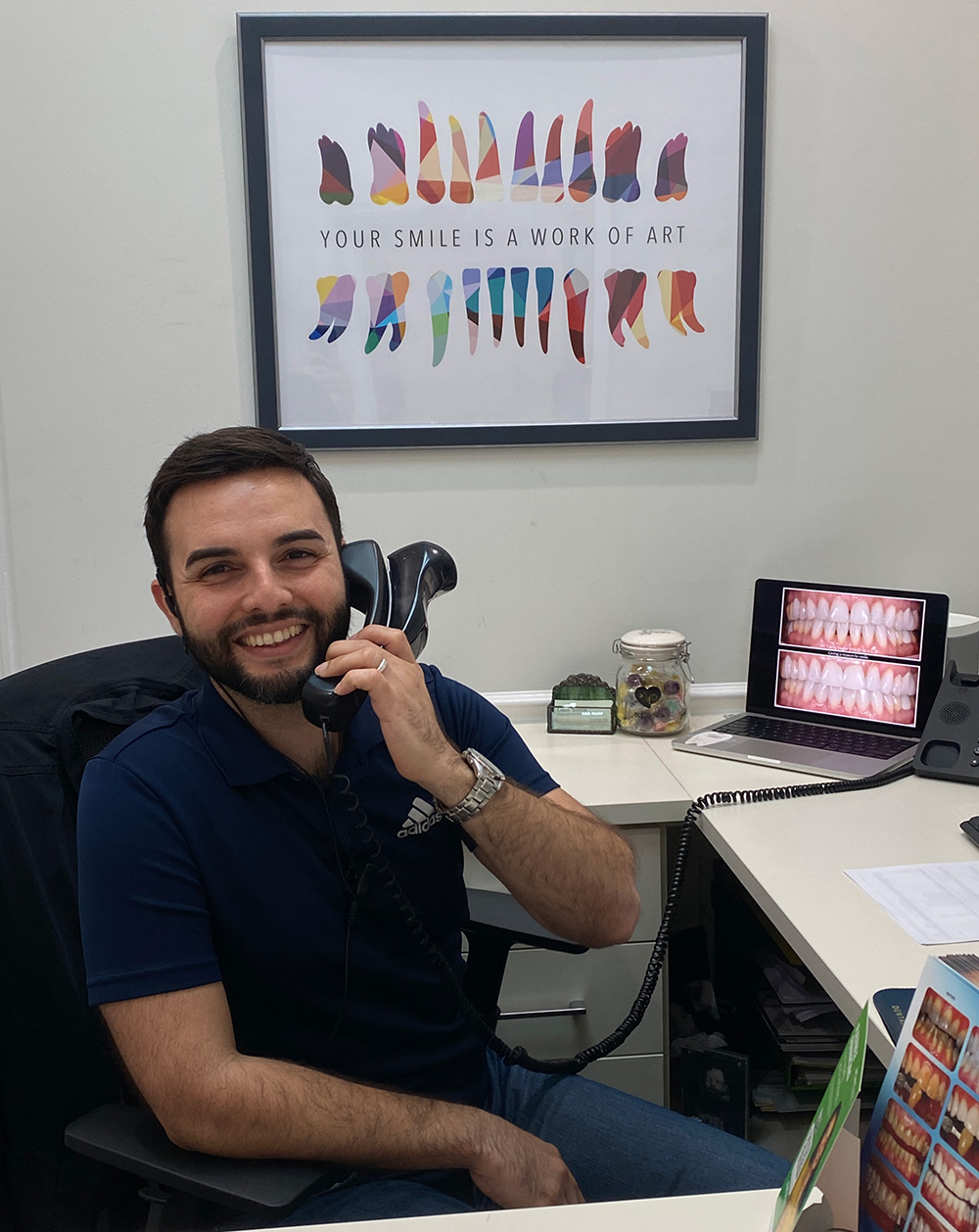 Team member on the phone at the Larry Saylor Dentistry front desk