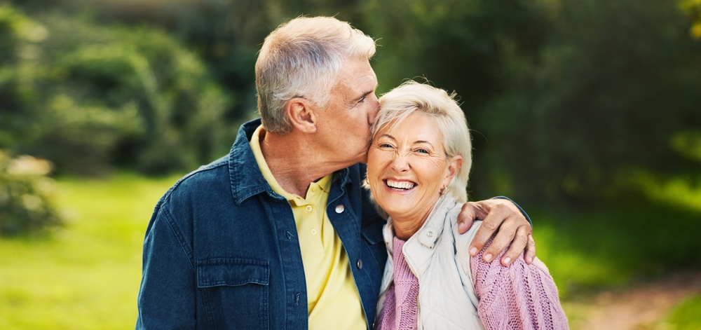 Smiling older couple embracing outdoors